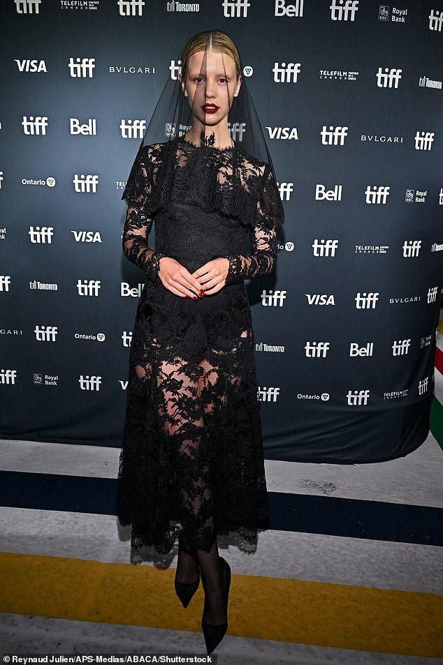 Mia Goth wears a dramatic lace veil and matching dress at ...