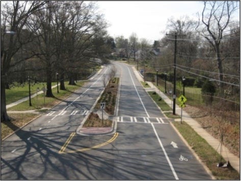 Charlotte Complete Streets-Rozzelles Ferry Road  Charlotte completely revamped Rozzelles Ferry Road. The streetscape was enhance by the addition of street trees and planting strips, while pedestrian crossing opportunities--as indicated by the crosswalk and corresponding refuge median--were added along the length of the road to make walking a breeze. The bike lanes facilitate cycling on road that previously unsuitable for riding. Photo: Charmeck.org (via Flickr, Creative Commons license)