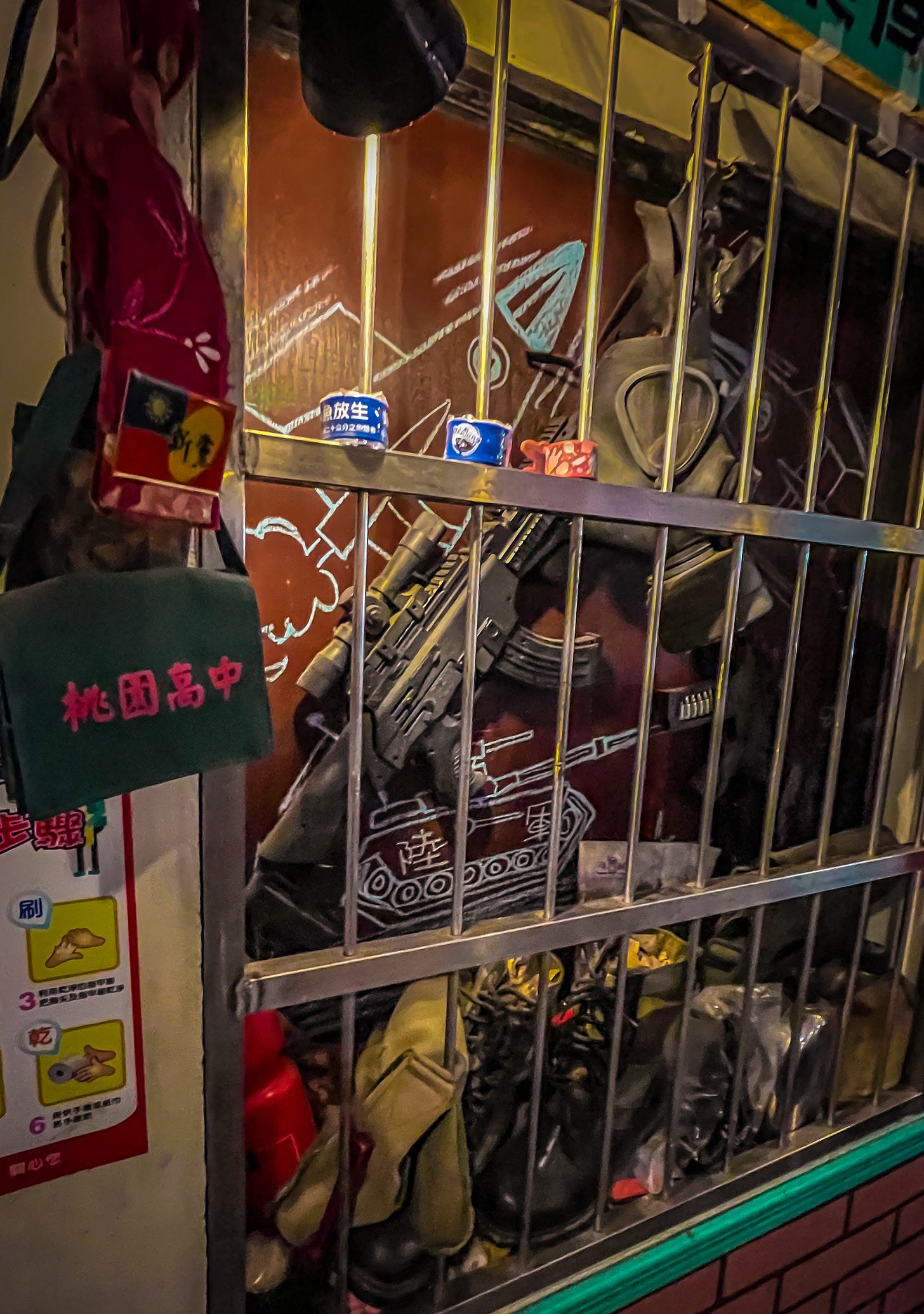 A Taiwanese army-issue machine gun and gas mask hang in a locked display case in the dining room of Army Diner in Taoyuan A Taiwanese army-issue machine gun and gas mask hang in a locked display case in the dining room of Army Diner in Taoyuan