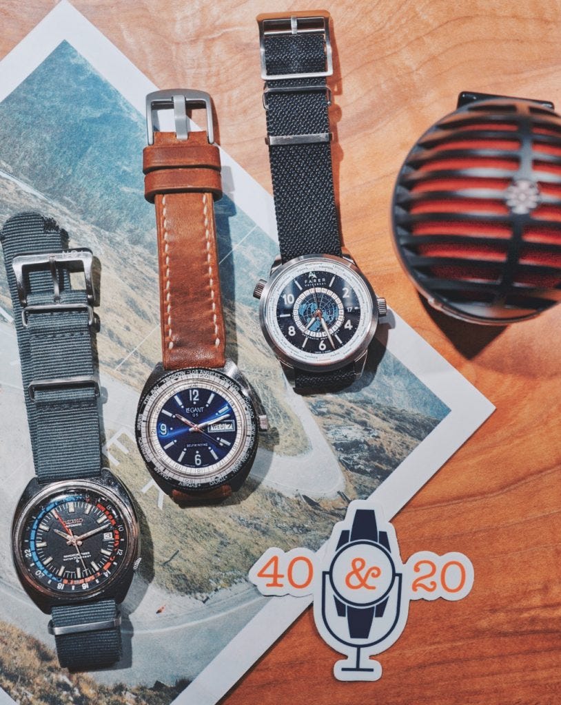 Three different worldtime and gmt watches ontop of a newspaper with a microphone and the 40&20 podcast sticker