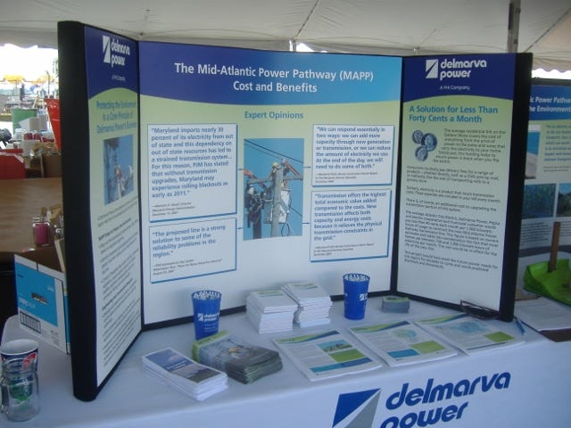 Delmarva Power explained the need for the Mid-Atlantic Power Pathway with this three-panel display at the Tawes Crab and Clam Bake last week. Their claim is that they need this line to assure continued reliability.