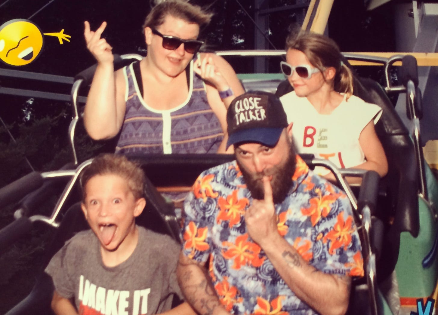 Deanna and her then-boyfriend-now-husband Matt are sitting on a rollercoaster with her niece and nephew while making funny faces. 