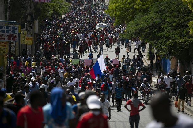 Demonstrators are seen marching in the streets during a protest.