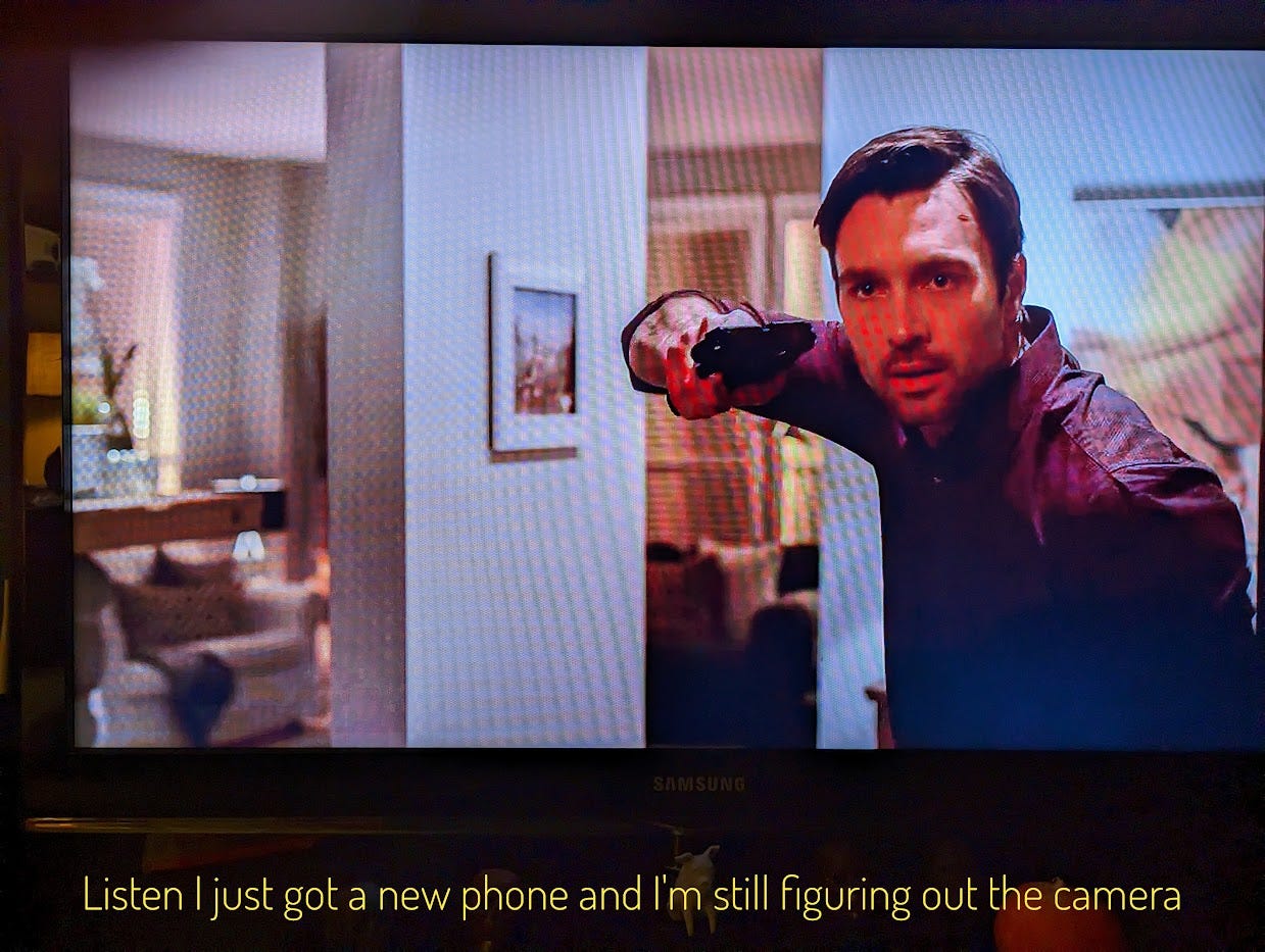 Luke holding a gun sideways, also the picture is all lined because it's a screen. Captioned "Listen I just got a new phone and I'm still figuring out the camera"