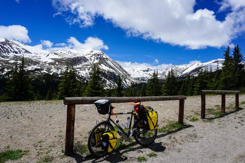 A picture of a bicycle on the Trans-American bicycle trail. There are mountains and forest in the background