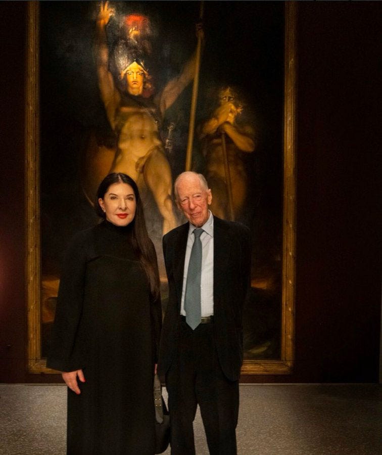 Marina Abramovic Poses with Jacob Rothschild in Front of the Painting "Satan Summoning His Legions"