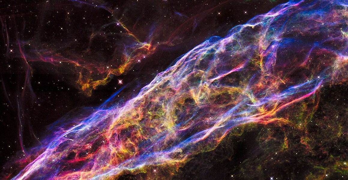 A brighltly coloured mosaic of images taken by the Hubble Space Telescope showing remnants of a massive star supernova that exploded about 8,000 years ago. Known as the Veil Nebula.