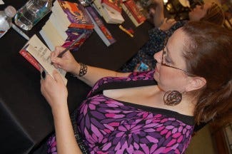 author michele bardsley signing a book