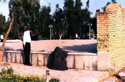 Family members of a victim overlook a cemetery dotted with unmarked graves. Many of the dead were simply unidentifiable due to the extent of their burns in the Cinema Rex fire