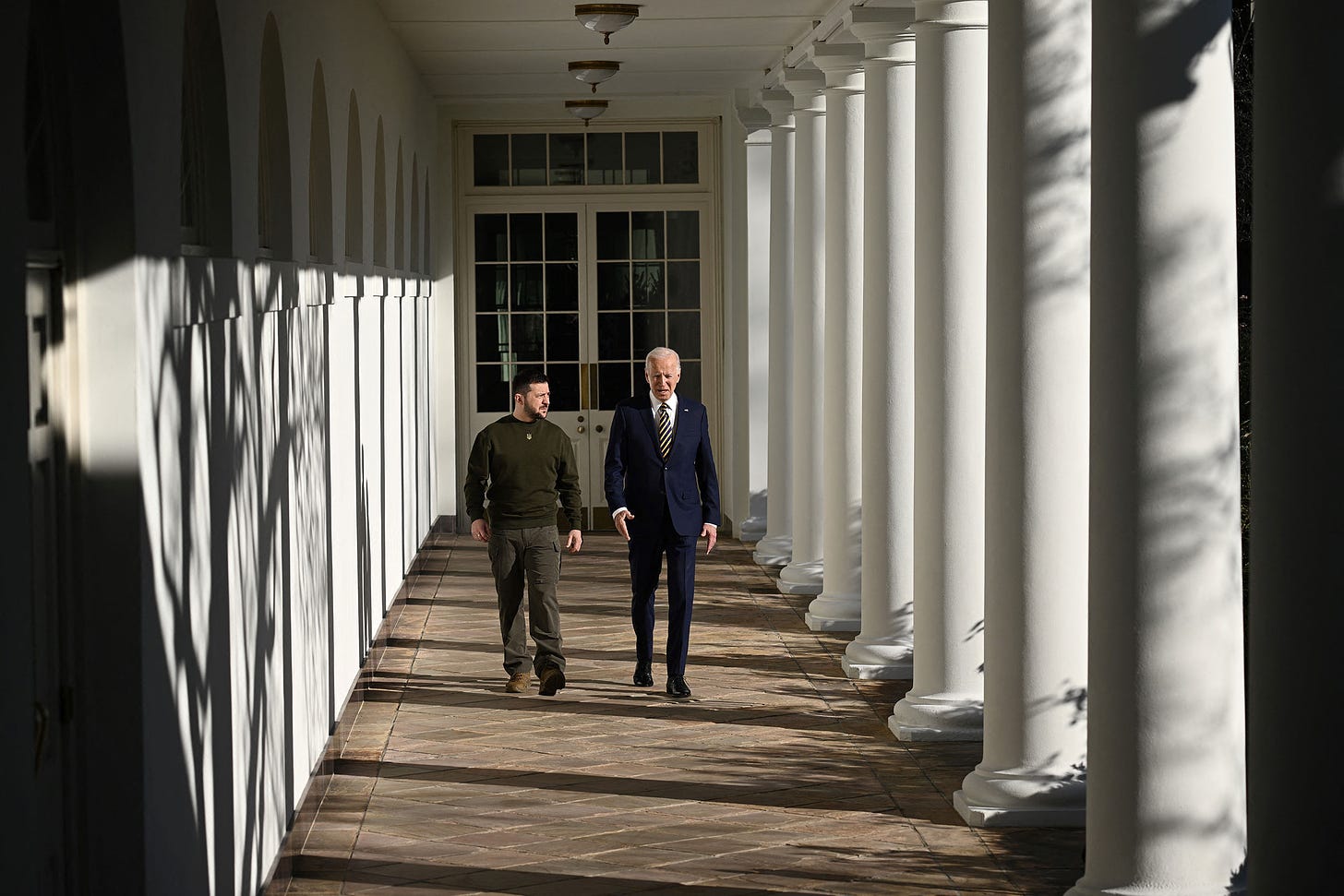 Ukrainian President Volodymyr Zelensky and US President Joe Biden walk through the White House colonnade on Wednesday.