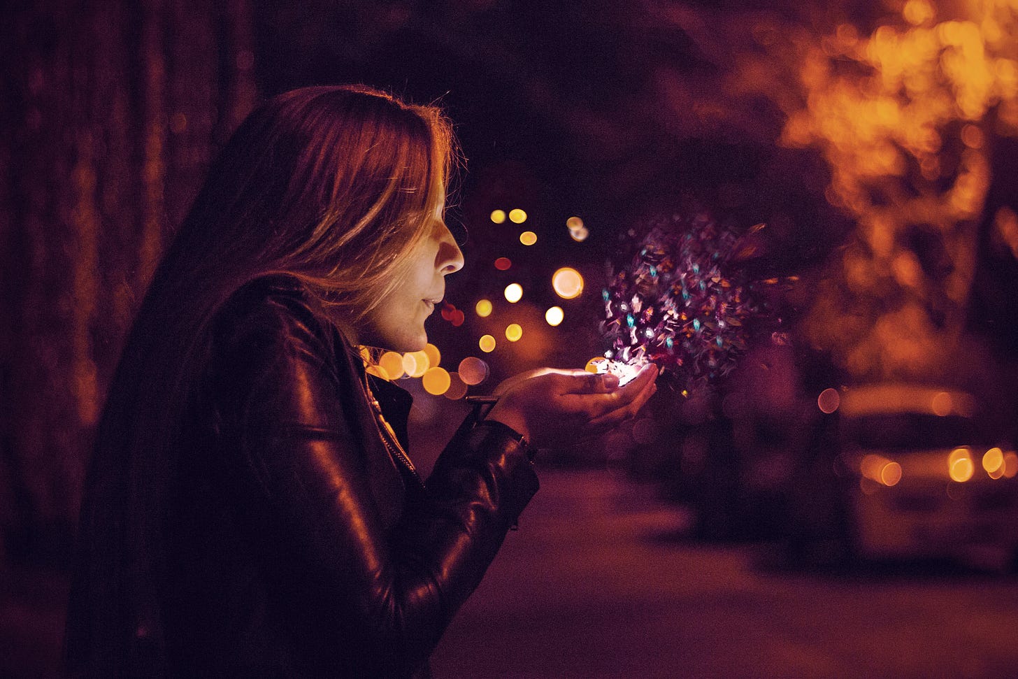 Woman blowing sprinkle in her hand photo