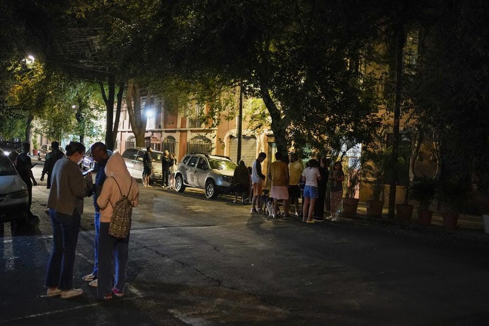 People gather outside after an earthquake was felt in Mexico City, Thursday, Sept. 22, 2022. The earthquake struck early Thursday, just three days after a deadly earthquake shook western and central Mexico. (AP Photo/Eduardo Verdugo)