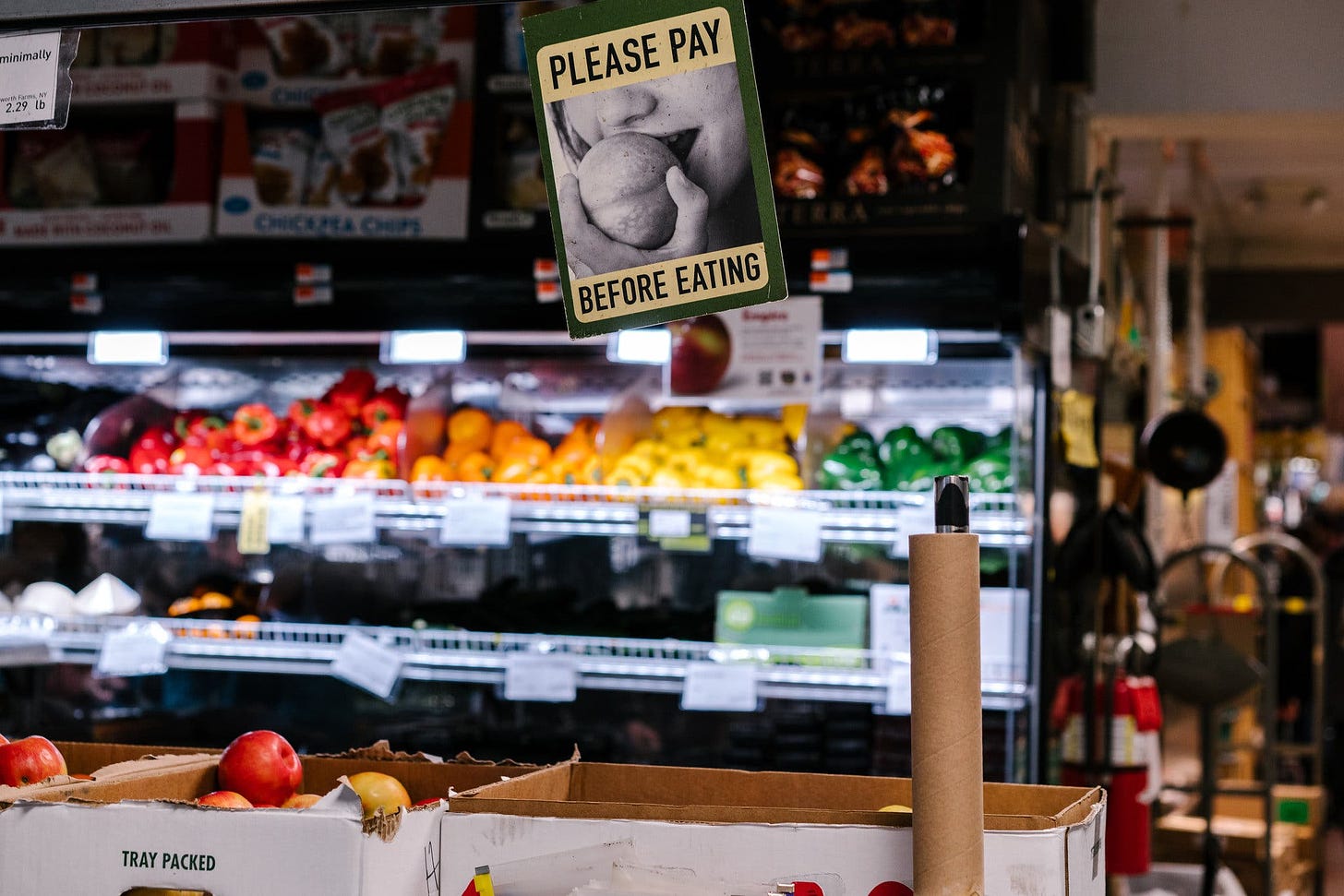 A photo of the Park Slope Food Co-Op with a sign that reads “Please Pay Before Eating.”