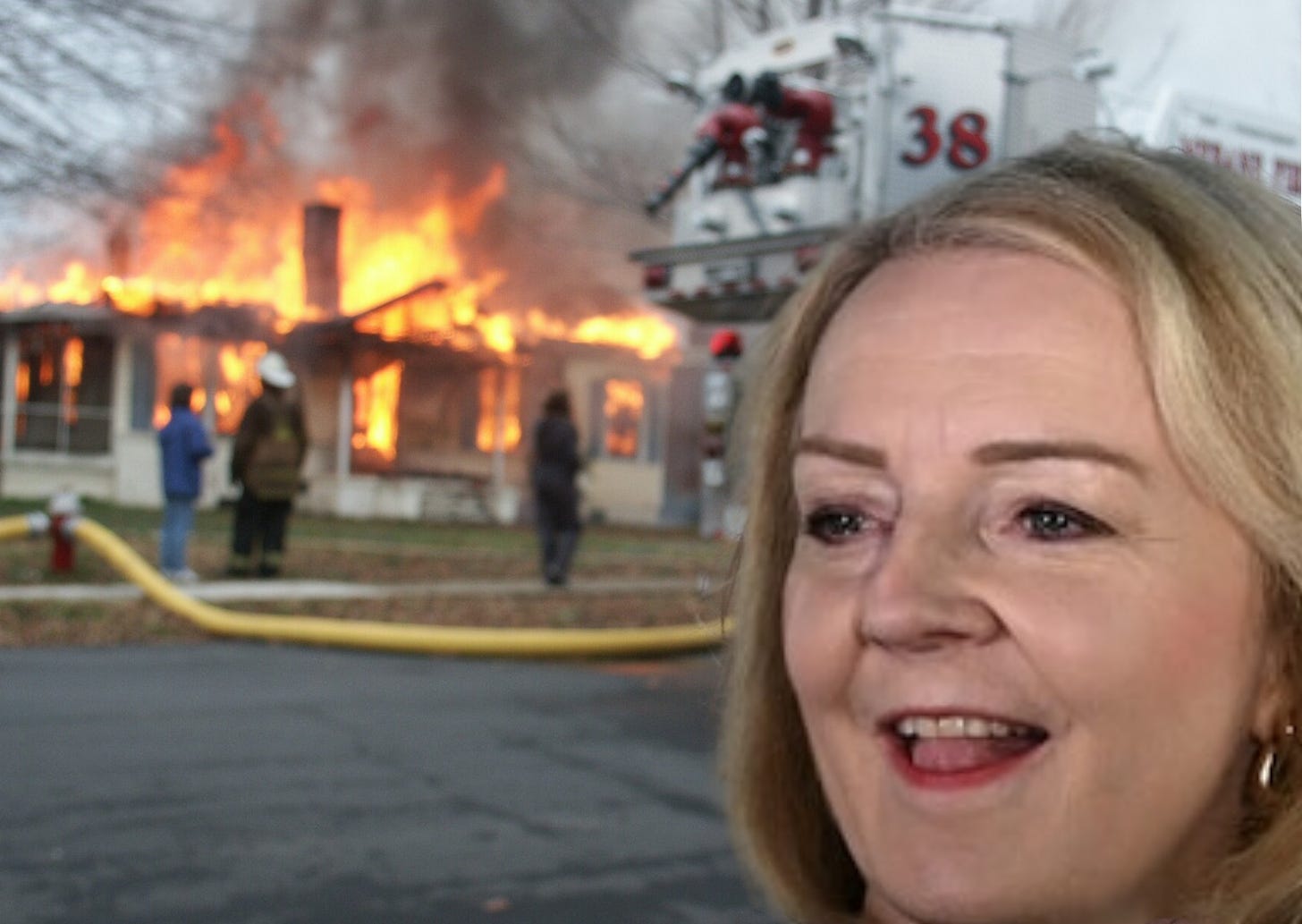 Liz Truss smiling in front of a burning house