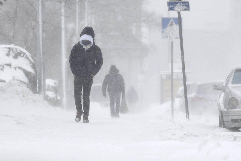 A man walking alone through a blizzard.