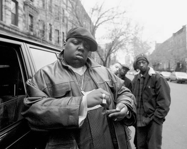 Rapper Notorious B.I.G., aka Biggie Smalls, aka Chris Wallace rolls a cigar outside his mother's house in Brooklyn.