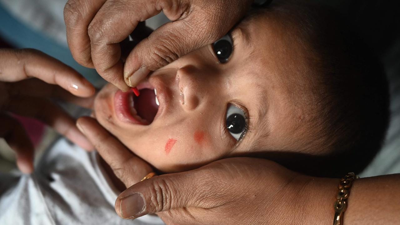 A health worker administers a vaccine to a child at a temporary vaccination camp following a measles outbreak that has caused the death of 10 children. Picture: Indranil Mukherjee/AFP.