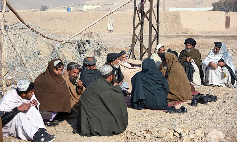 In this photo taken on February 9, 2019, internally displaced Afghan men talk in Kandahar city, after fleeing conflict with the Taliban in the Deh Rawood district of Uruzgan province. —AFP