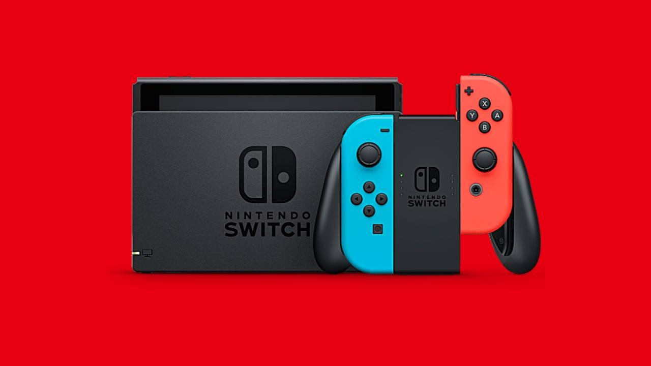 Nintendo Switch, dock, and Joy-Con grip against a red background