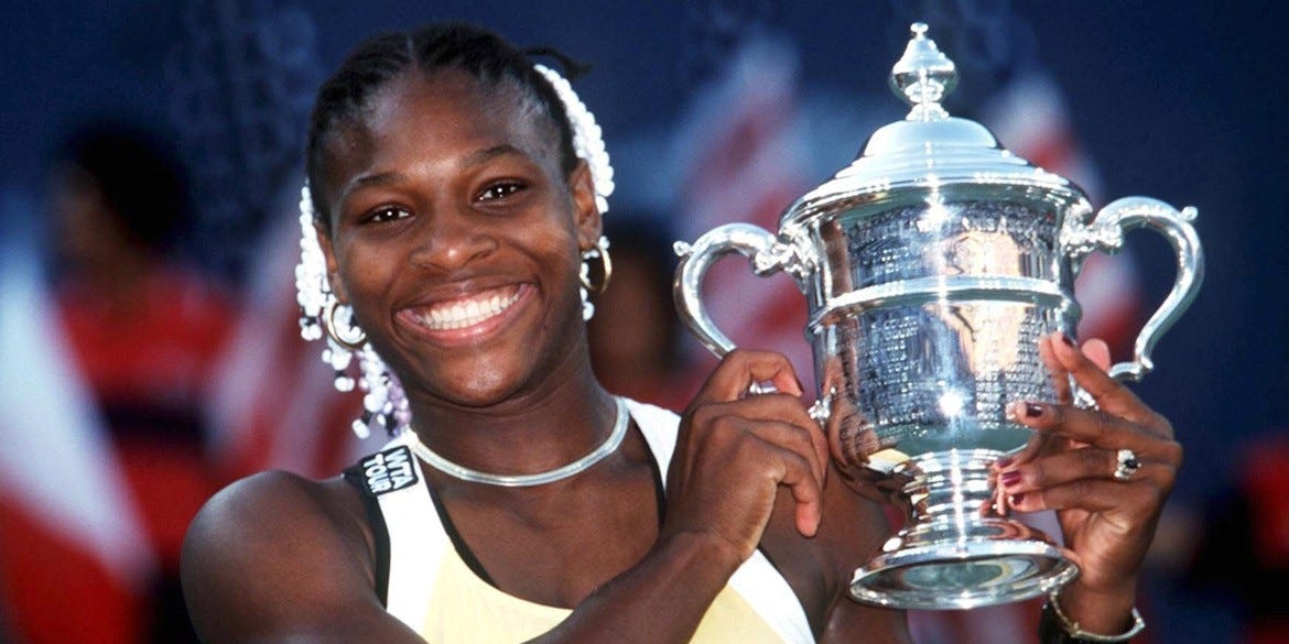 Serena Williams holding her trophy after winning the 1999 US Open.