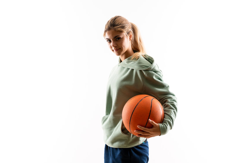 teen girl playing basketball