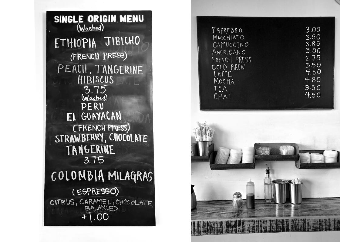 Close-ups of the black, chalkboard menu boards hanging on a white wall at Zumbar coffee. Coffee options and prices are listed in simple block letters.