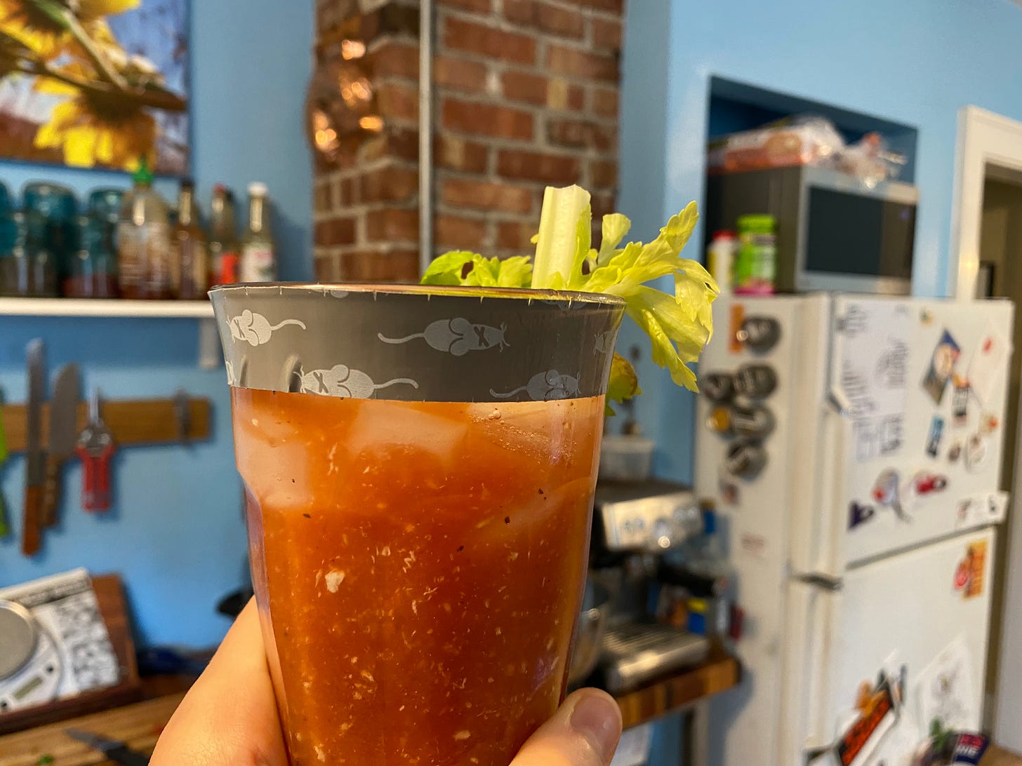 A Bloody Mary with a strip of gray vinyl mouse tape around the lip of the glass.