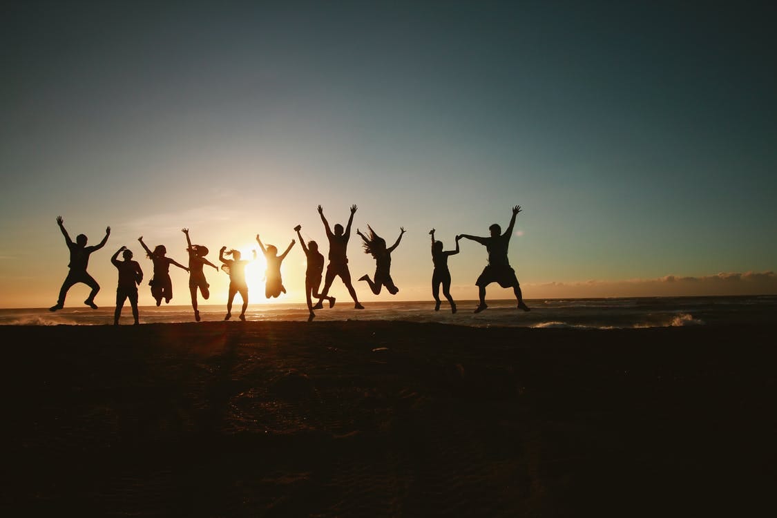 Free Silhouette Photography of Group of People Jumping during Golden Time Stock Photo