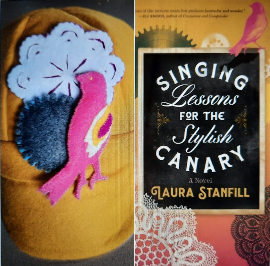A gold wool hat with lace doily, gray gear, and pink canary, matching the book cover for SINGING LESSONS FOR THE STYLISH CANARY.