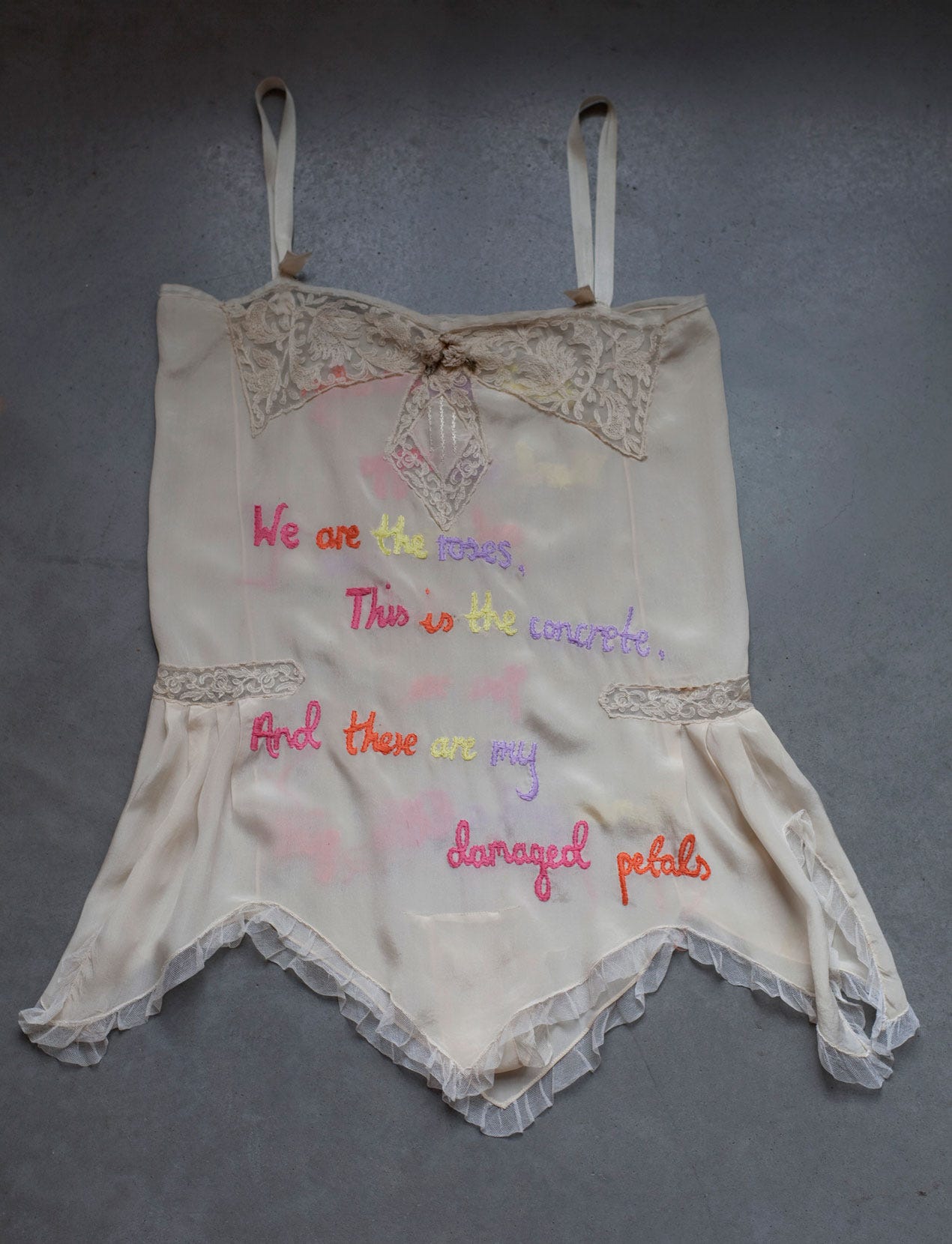 Modern artwork: 2pac 90's rap lyrics embroidered on vintage lingerie slip.