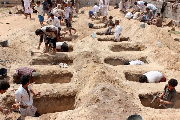 Yemenis dig graves for children killed when their bus was hit during a Saudi-led coalition airstrike in 2018.