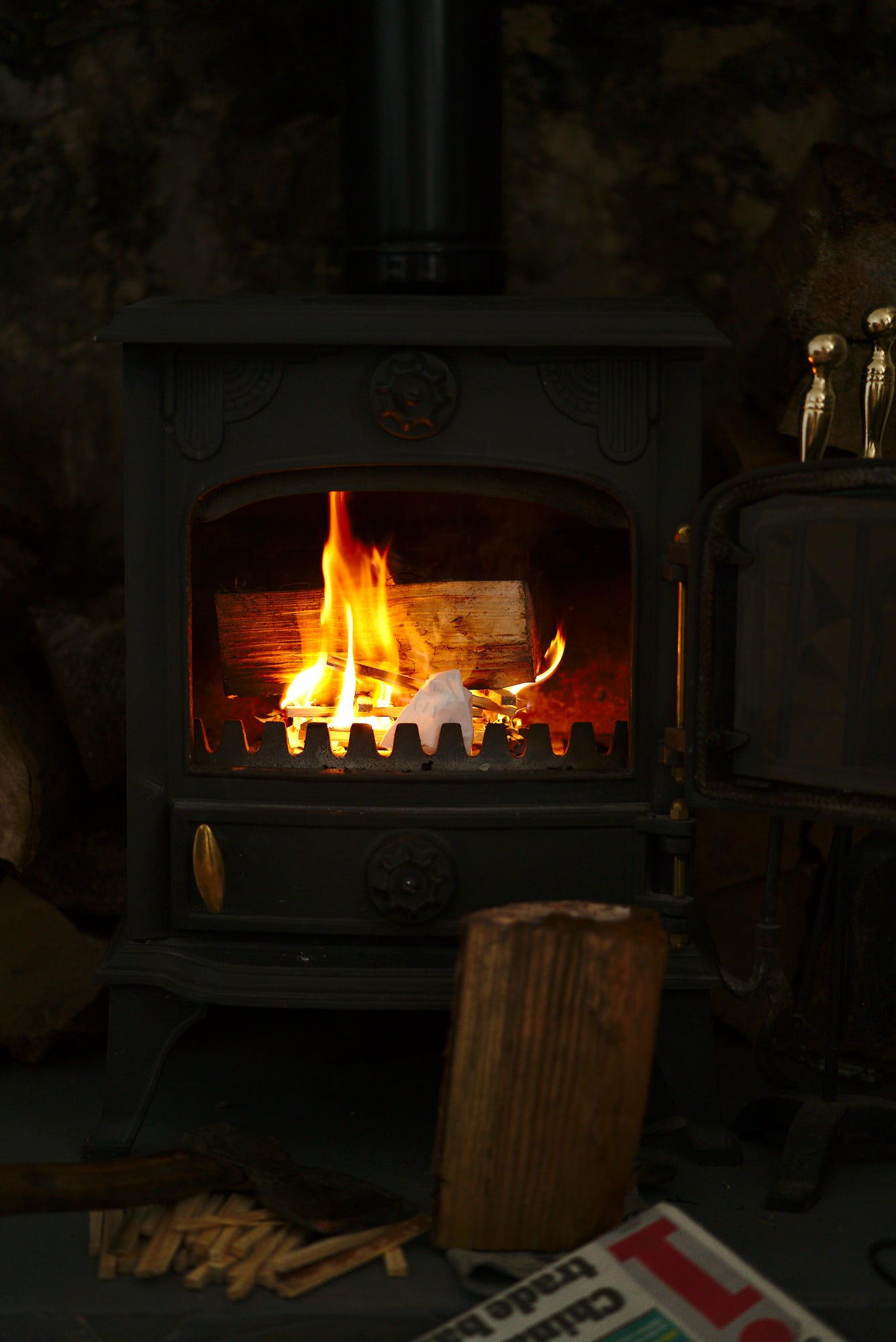 The small wood burning stove in our cottage in Combe St. Nicholas, UK, with some wood shavings sitting in front of it. This is the first day it has been cool enough to get it started.