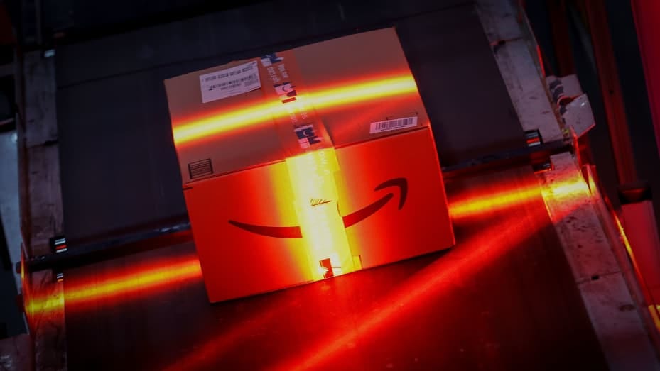 A fast-moving conveyor belt moves a package through a scanning machine on its way to a delivery truck during operations on Cyber Monday at Amazon's fulfillment center in Robbinsville, New Jersey, U.S., November 29, 2021.