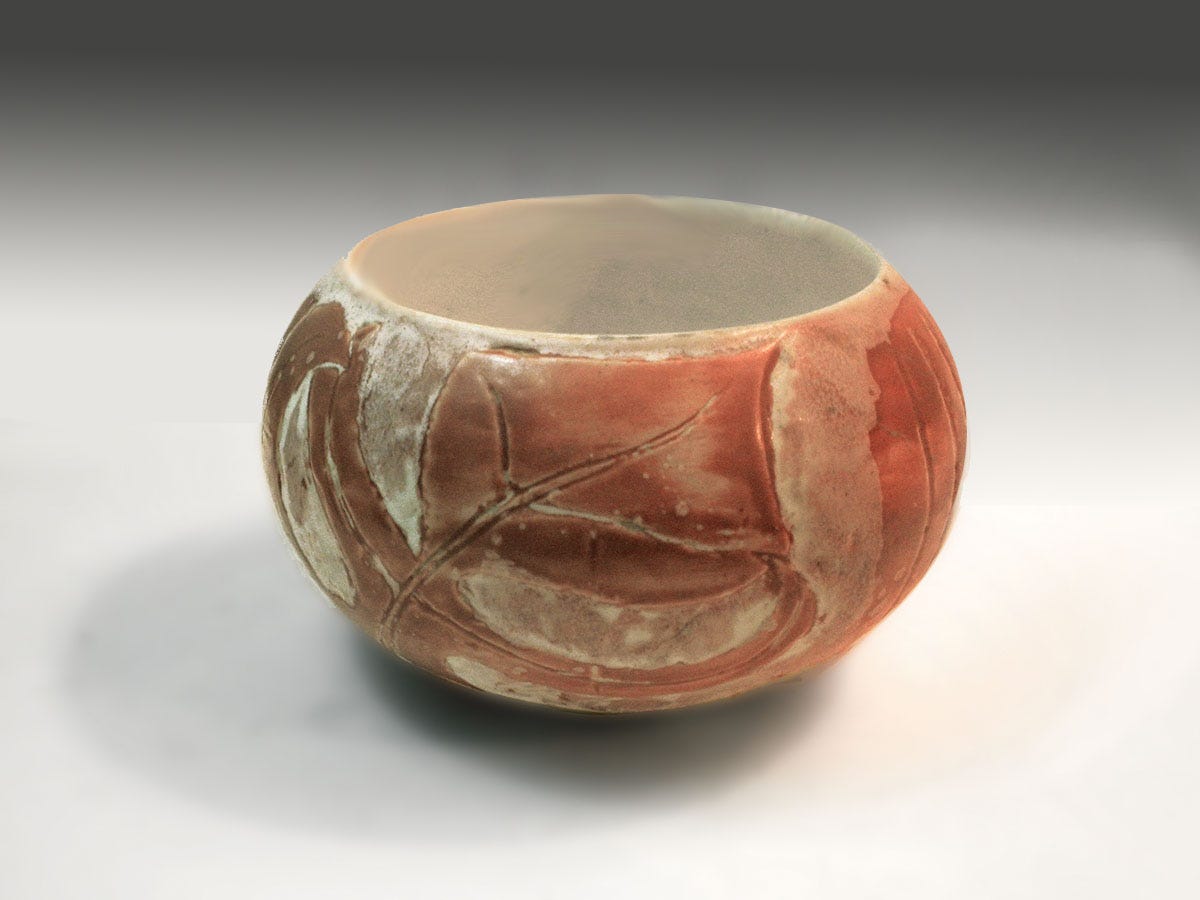 A small bowl of simple form slip-cast extra thick to allow the artist to carve into the form, id glazed in white and brushed with coral decorating color to create a primitive-modern abstract effect in this one of a kind art object by Weston Neil Andersen.