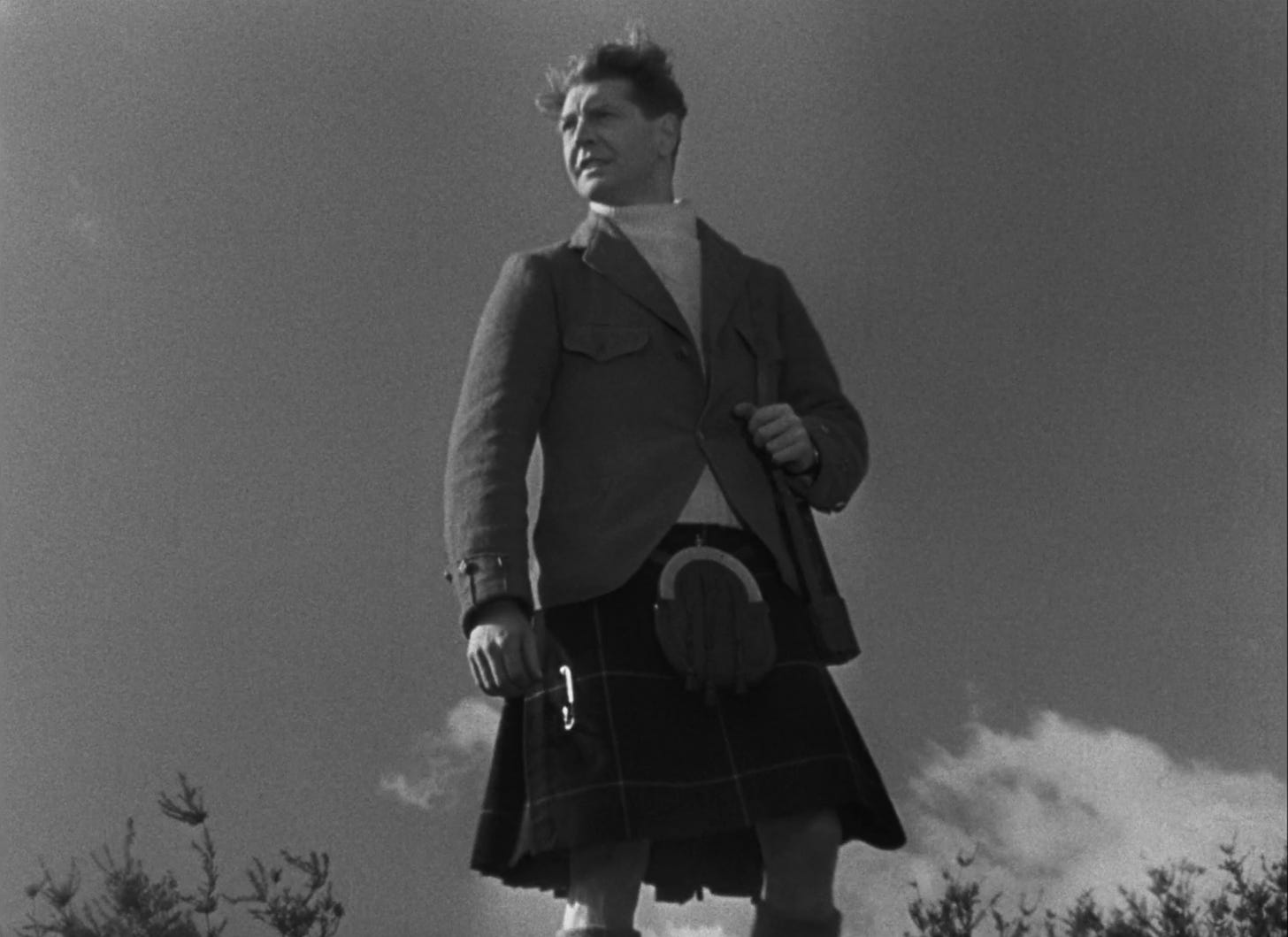 Roger Livesey as Tonquil MacNeil wearing a coat, a sweater, and a kilt (with the pouch in front) in I KNOW WHERE I'M GOING!