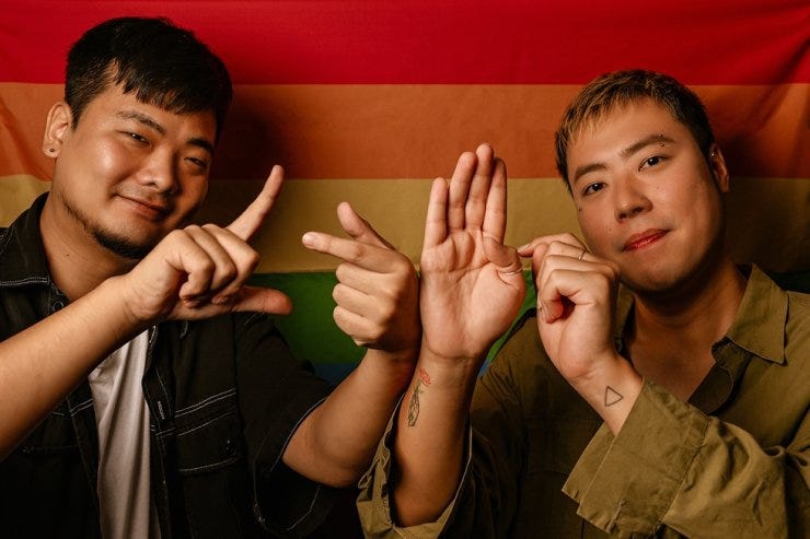                                                                                                  Woo Ji-yang, left, and Kim Bo-seok, Korean Deaf LGBT activists, sign 'LGBT' in Korean Sign Language during an interview with The Korea Times in Seoul, Monday. The group created 37 alternative sign expressions that sexual minorities can use with pride. Korea Times photo by Shim Hyun-chul                        