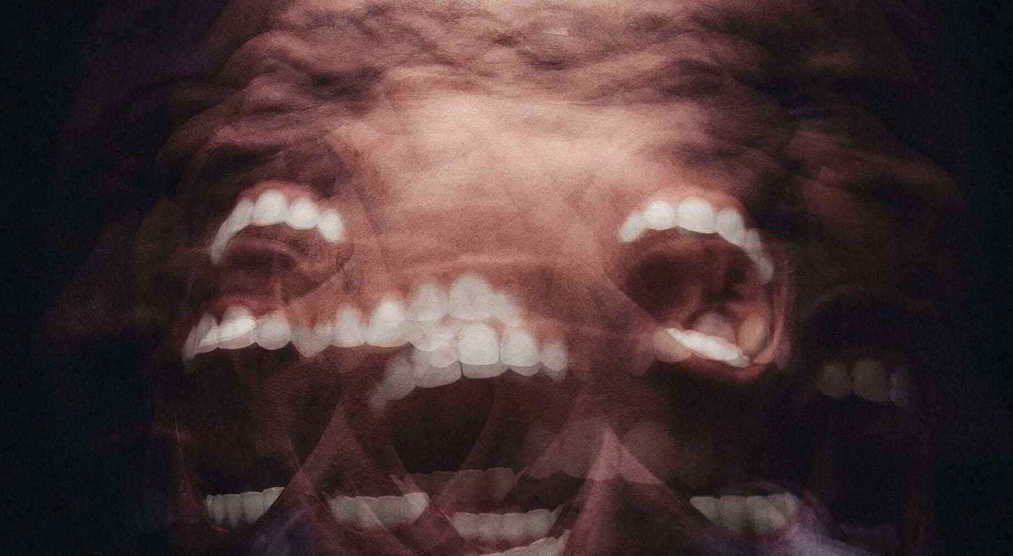 alt="A man's face with mouth open, white teeth showing, blurred together in many different positions to look like he's deranged and screaming"