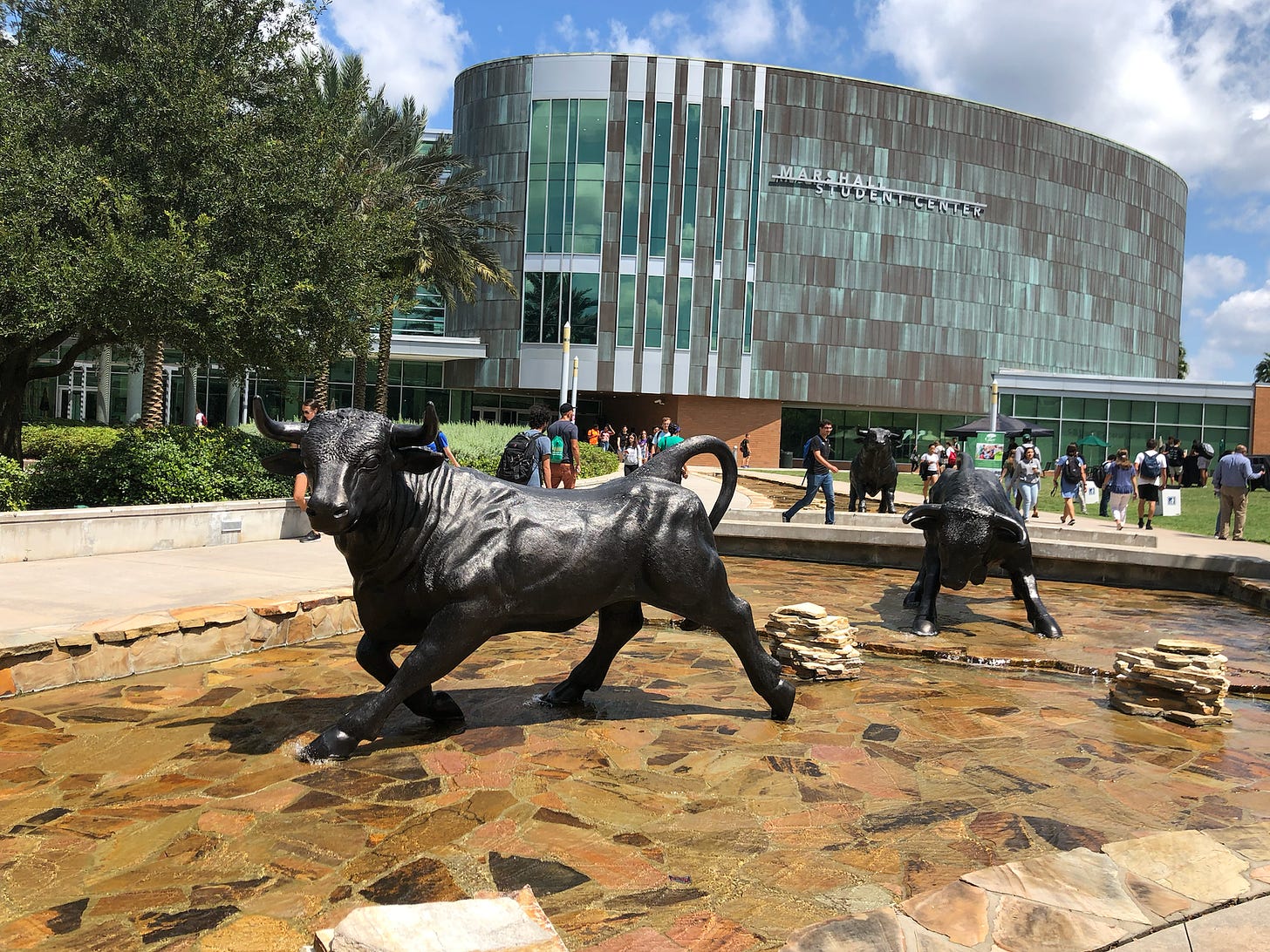 A statue of three running bulls in front of South Florida's student center.