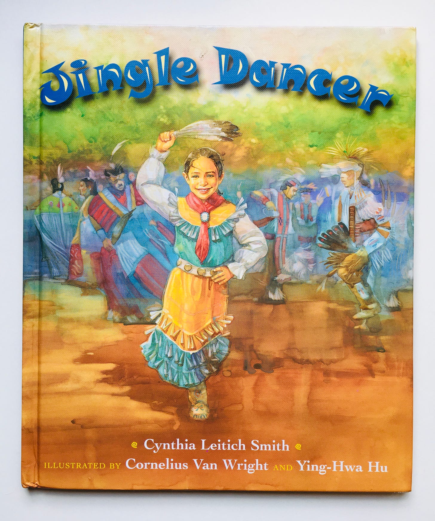 A young Muscogee Creek girl faces the viewer as she performs a jingle dance with others