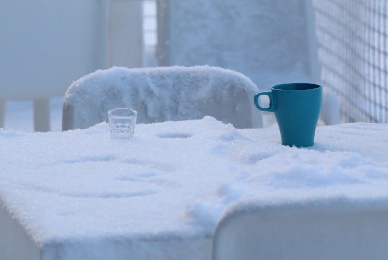 snow on table, a cup and a glass