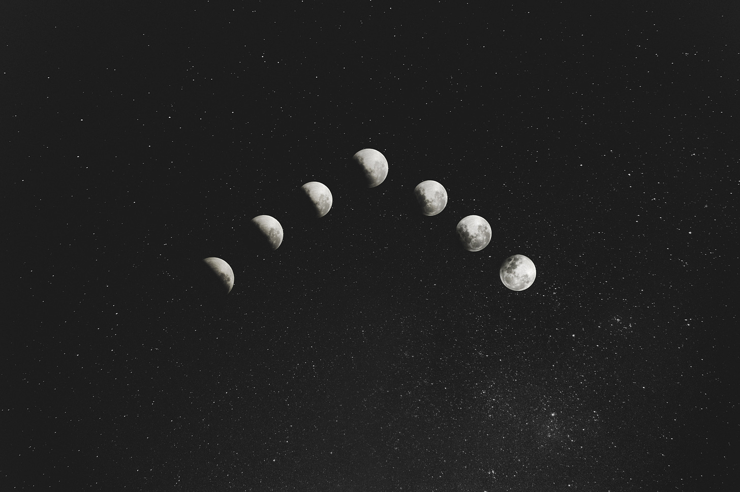 the moon in its different phases on a background of stars