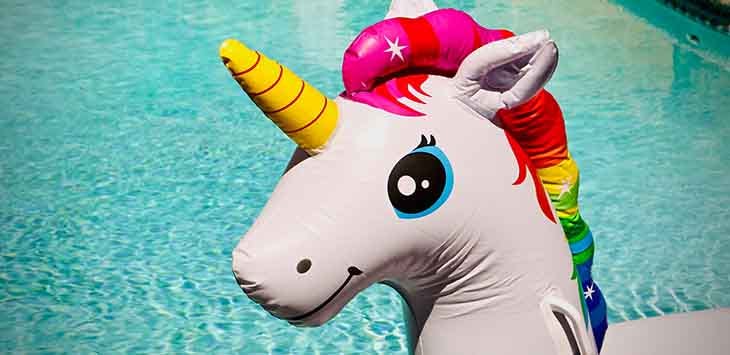 Photo of inflatable unicorn toy next to a swimming pool