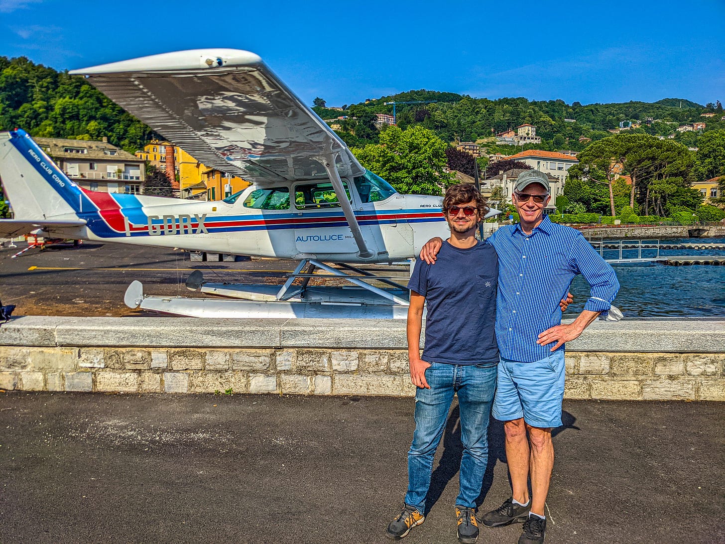 Michael and Javier standing in front of the floatplane, safely on the ground. 