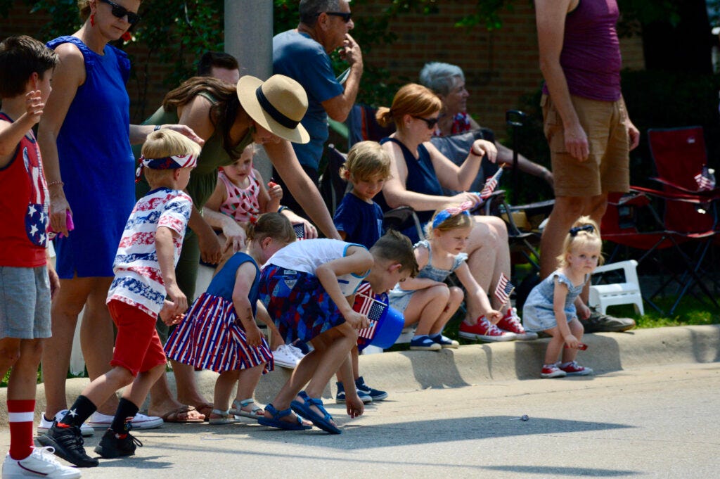 Children scramble to pick up candy Sunday, July 4, during the parade. PHOTOS BY JON DEPAOLIS/RICHARD FREE PRESS