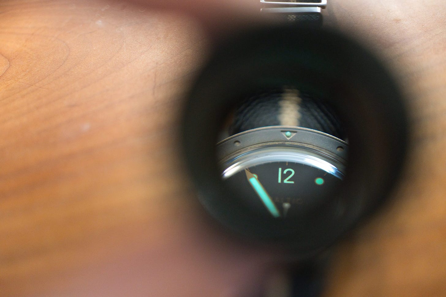 Loupe magnifying a self placed pip on the triagnle of the bezel of the Baltic Bronze