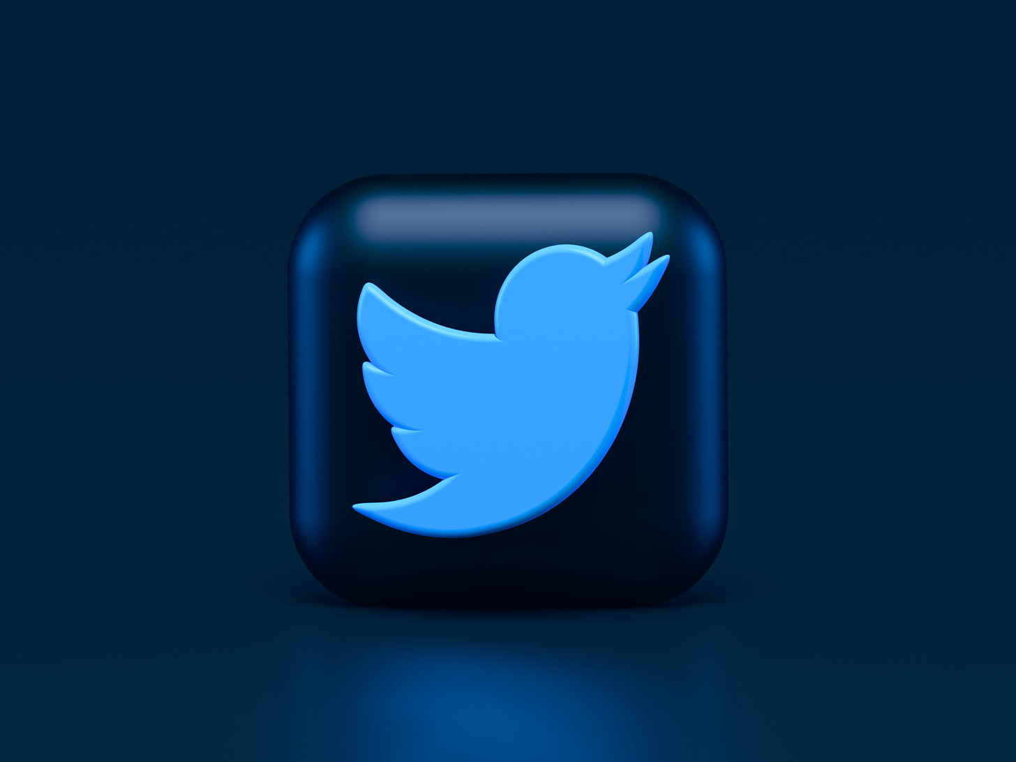 twitter bird on a button against a dark blue background.