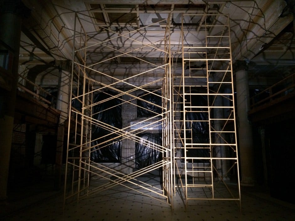 a towering golden scaffold, dramatically uplit to cast a web of broken shadows on the walls and ceiling of a dilapidated ballroom