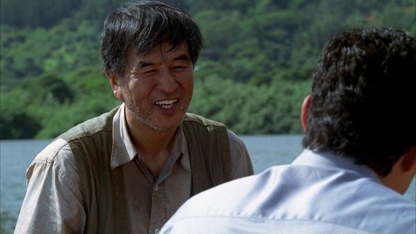 A lakeshore scene. Mr. Kwon (John Shin) speaks to his son, Jin-Soo Kwon (Daniel Dae Kim).