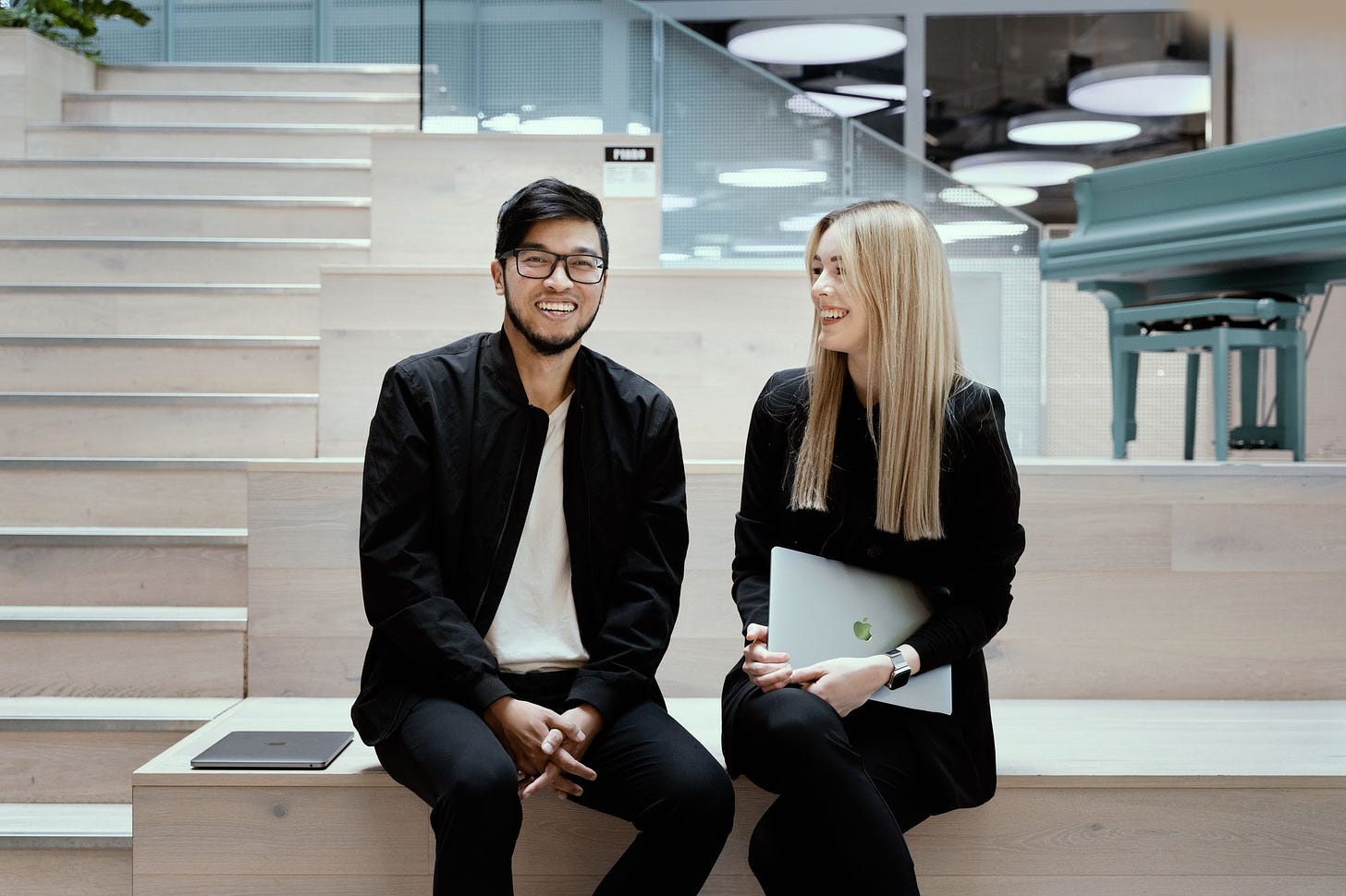 Talkbase co-founders Klara Losert and Roman Nguyen sitting and smiling
