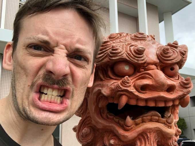 Andy Fossett poses with a Shisa in Okinawa